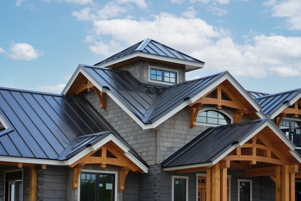 metal roofs. Close-up house retro roof panel with standing seam and fasteners. Classic style black metal panel with rebate joint. Modern galvanized steel roofing sheet with ribs. Falls roofing. Building's covering.