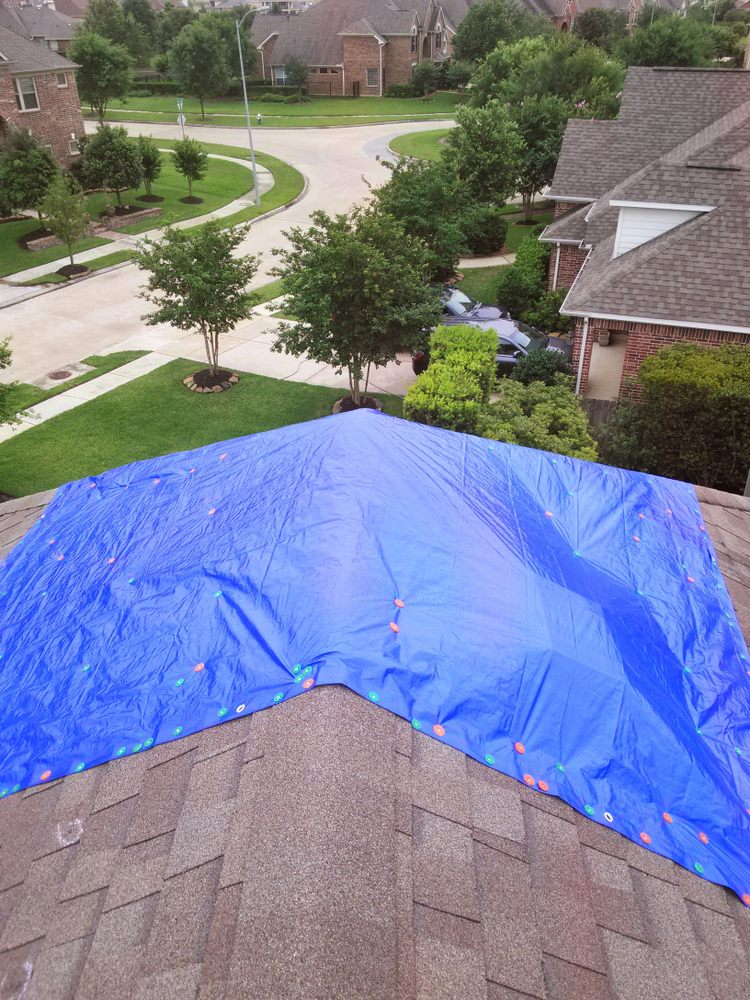 Roofing Services In Kanata. Blue tarp on roof of house. Need roof repair service.