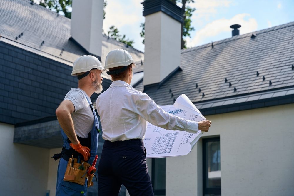 Roofing Services In Kanata. Builder and site supervisor conducting roof inspection.