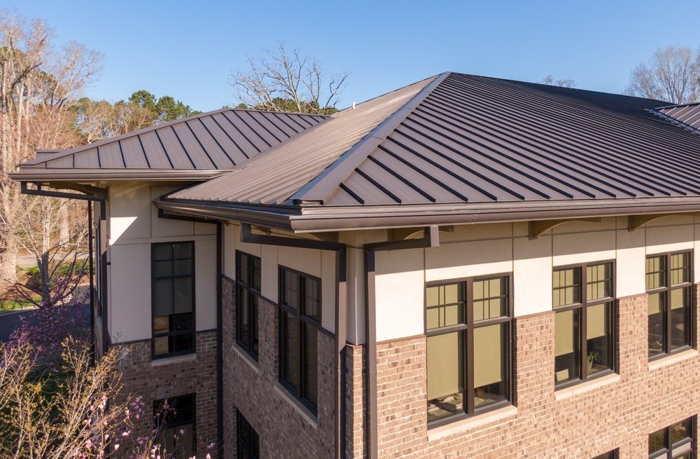 Roofing Services In Kanata. Sunny Daytime Drone Images Of a Brown Standing Seam Metal Roof On A house.